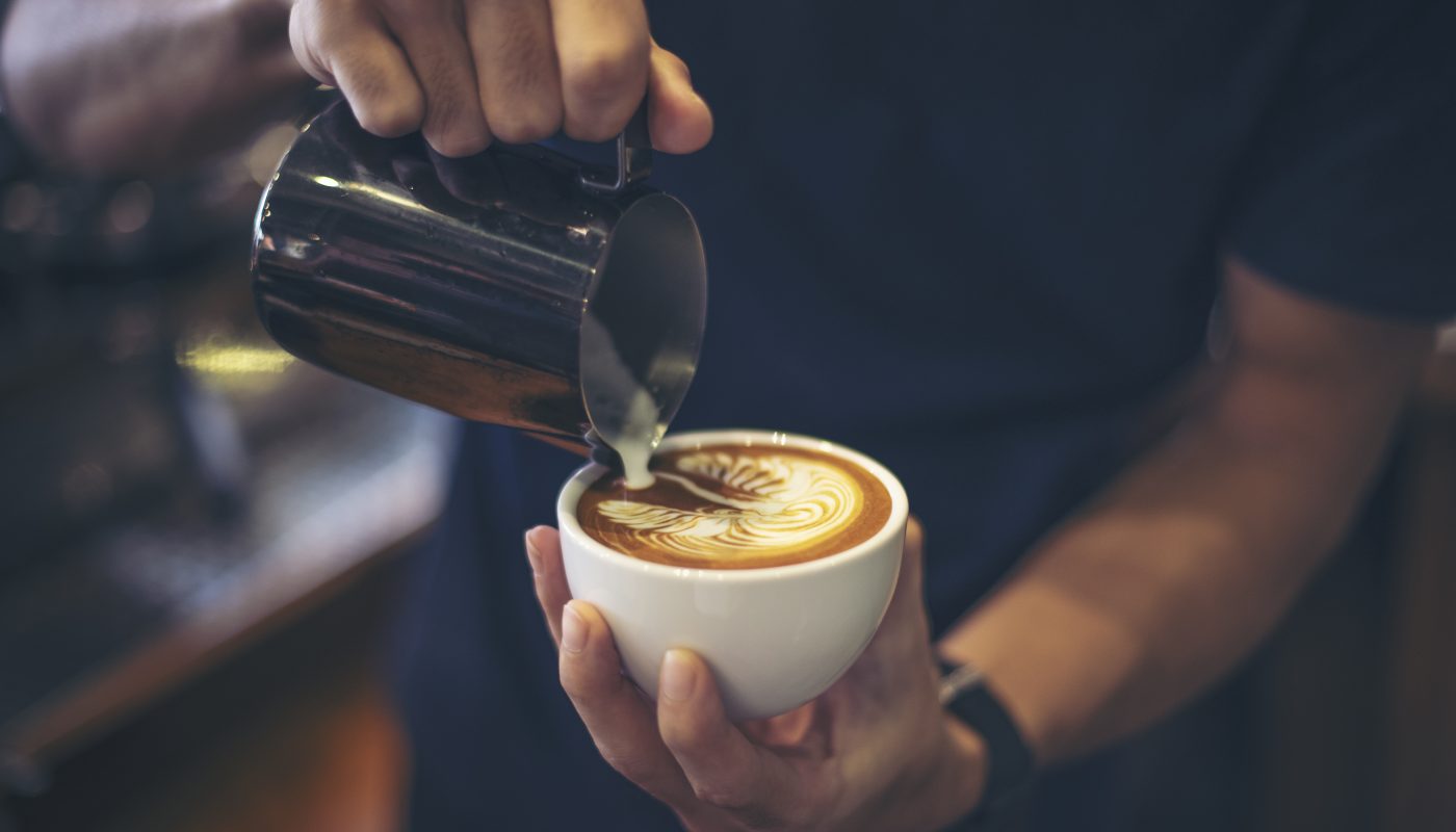 close up hands barista make latte coffee art paint
